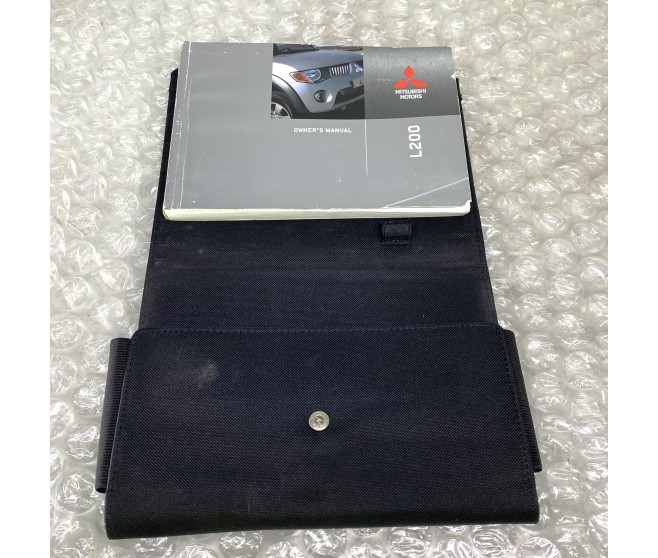 OWNERS HANDBOOK WITH WALLET FOR A MITSUBISHI L200,L200 SPORTERO - KB8T