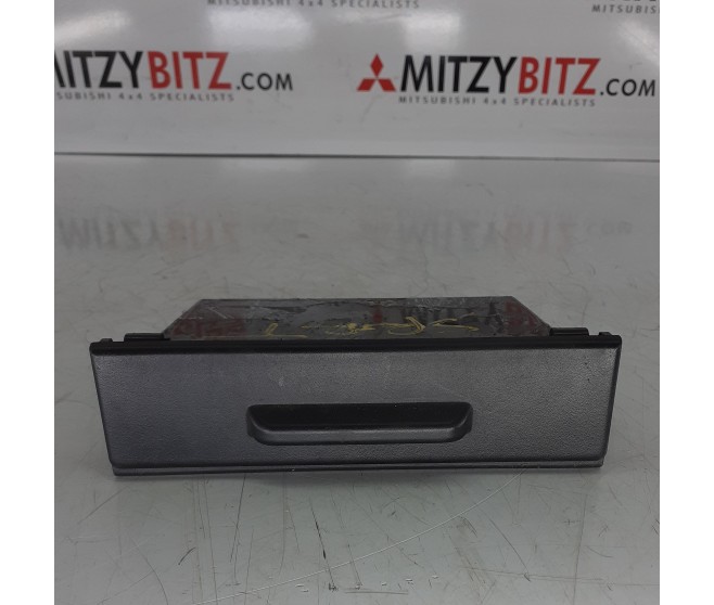 UNDER STEREO ACCESSORY BOX WITH LID TYPE FOR A MITSUBISHI PAJERO/MONTERO - V73W